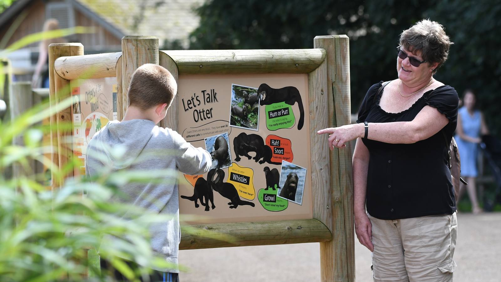Guests Looking At Sign
